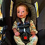 Sage joined the competition — help win amazing prizes! baby, car_seat, infant, child, onesie, straps, cushion, warning_label, safety, indoors, cute, small_hands, floral_pattern, seatbelt, looking, portrait, young_child, comfortable, car_safety, head_support