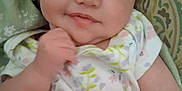Sage joined the competition — help win amazing prizes! baby, infant, smile, face, blue_eyes, hand, floral_clothing, cushion, blanket, closeup, person, cute, portrait, indoors, soft_lighting, child, skin, young, happy, resting