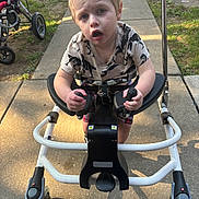 Ryan is registered to the contest to win money with this photo: baby, bicycle, e_scooter, face, furniture, grass, head, machine, nature, outdoors, park, person, photography, plant, portrait, spoke, stroller, transportation, vehicle, wheel