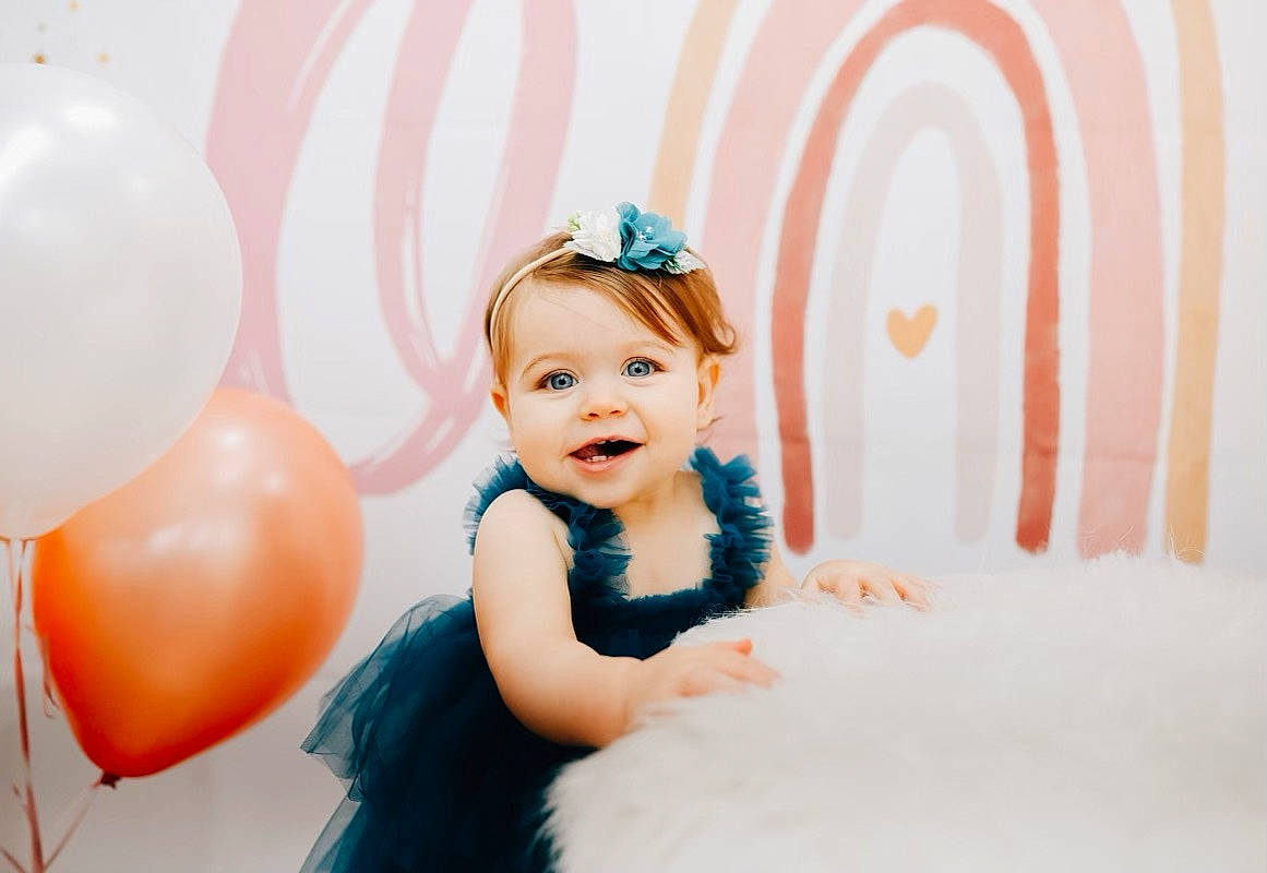 Emery is registered to the contest to win money with this photo: baby, baby_toddler_clothing, balloon, beauty, child, event, fashion_accessory, flash_photography, formal_wear, fun, hair_accessory, happy, headpiece, joy, magenta, party_supply, pattern, peach, person, pink