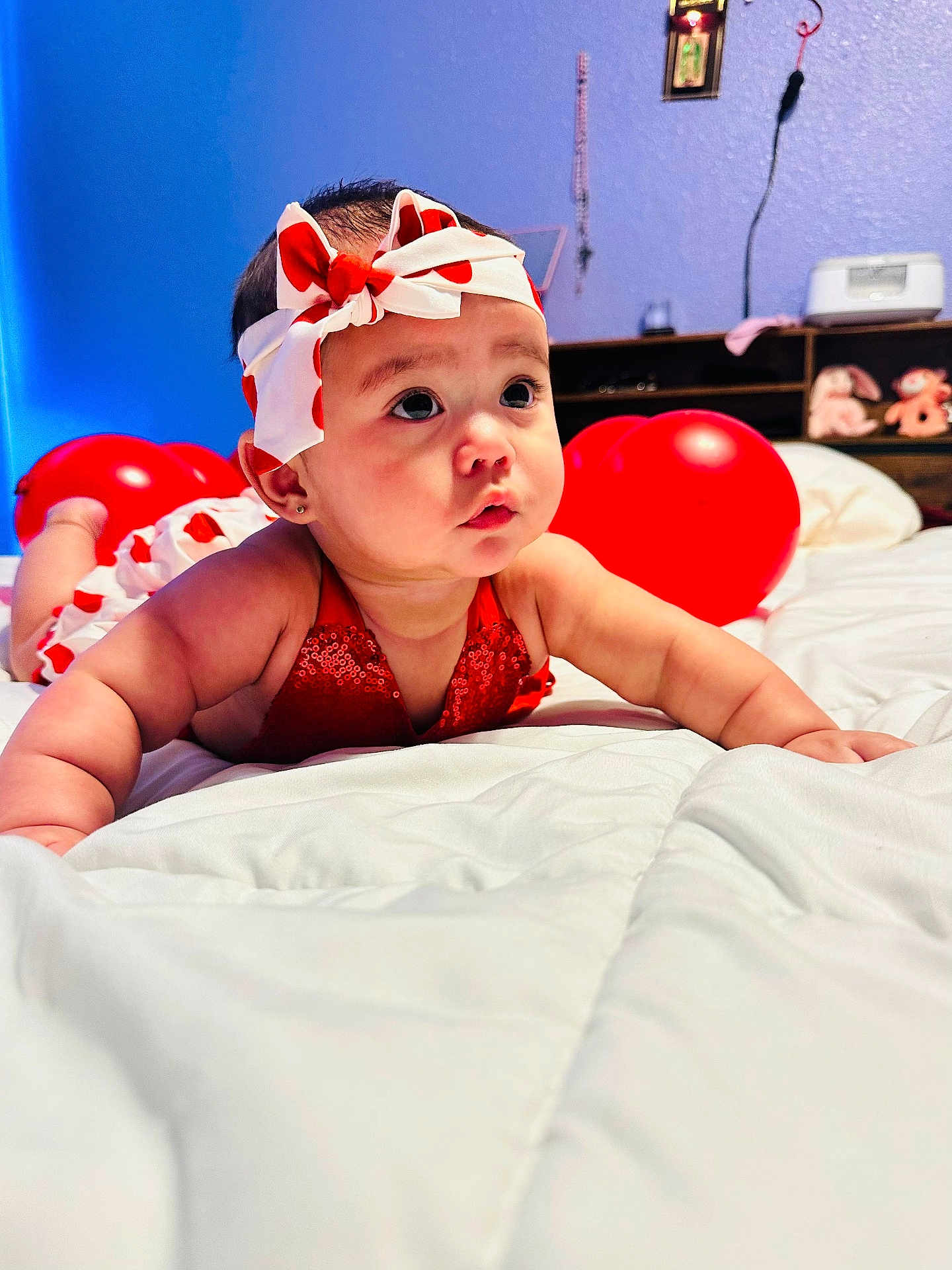 Olivia joined the competition — help win amazing prizes! baby, infant, headband, bow, red_balloon, bed, blanket, cute, portrait, big_eyes, chubby_cheeks, earrings, red_dress, nursery, toy, shelf, wall, colorful, playtime, expression