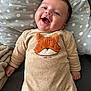 baby, smiling, infant, onesie, fox_applique, pillow, polka_dot, blanket, cozy, cute, happy, child, face, human, indoor, couch, soft, clothing, lying_down, portrait