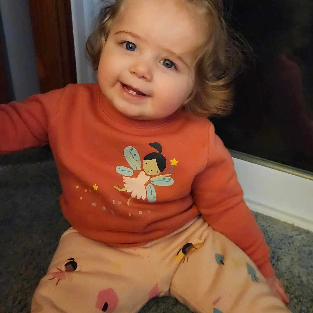 Addison joined the competition — help win amazing prizes! applique, baby, bodypart, clothing, door, face, finger, hand, happy, head, pajamas, pants, pattern, person, photography, portrait, sitting, skin, smile, tattoo