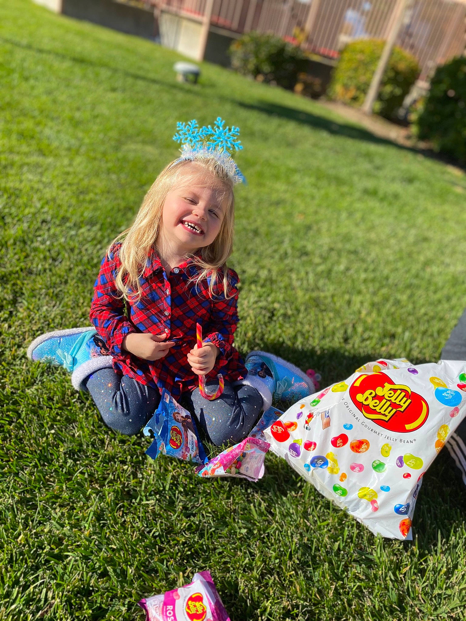 Mia is registered to the contest to win money with this photo: child, event, fun, grass, grass_family, green, happy, joy, lawn, leaf, leisure, pattern, people_in_nature, person, plant, recreation, sitting, smile, spring, summer