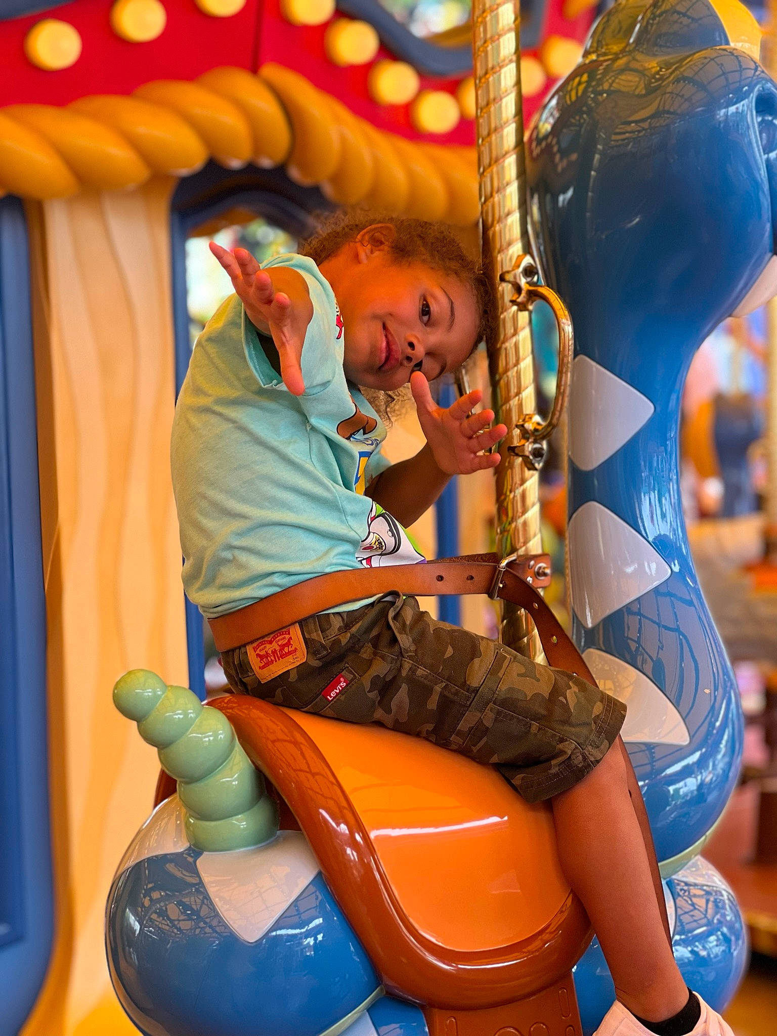 Dominick is registered to the contest to win money with this photo: amusement_park, amusement_ride, carousel, child, chute, event, fun, human_leg, human_settlement, joy, leisure, nonbuilding_structure, outdoor_play_equipment, person, play, playground, public_space, recreation, snapshot, thigh