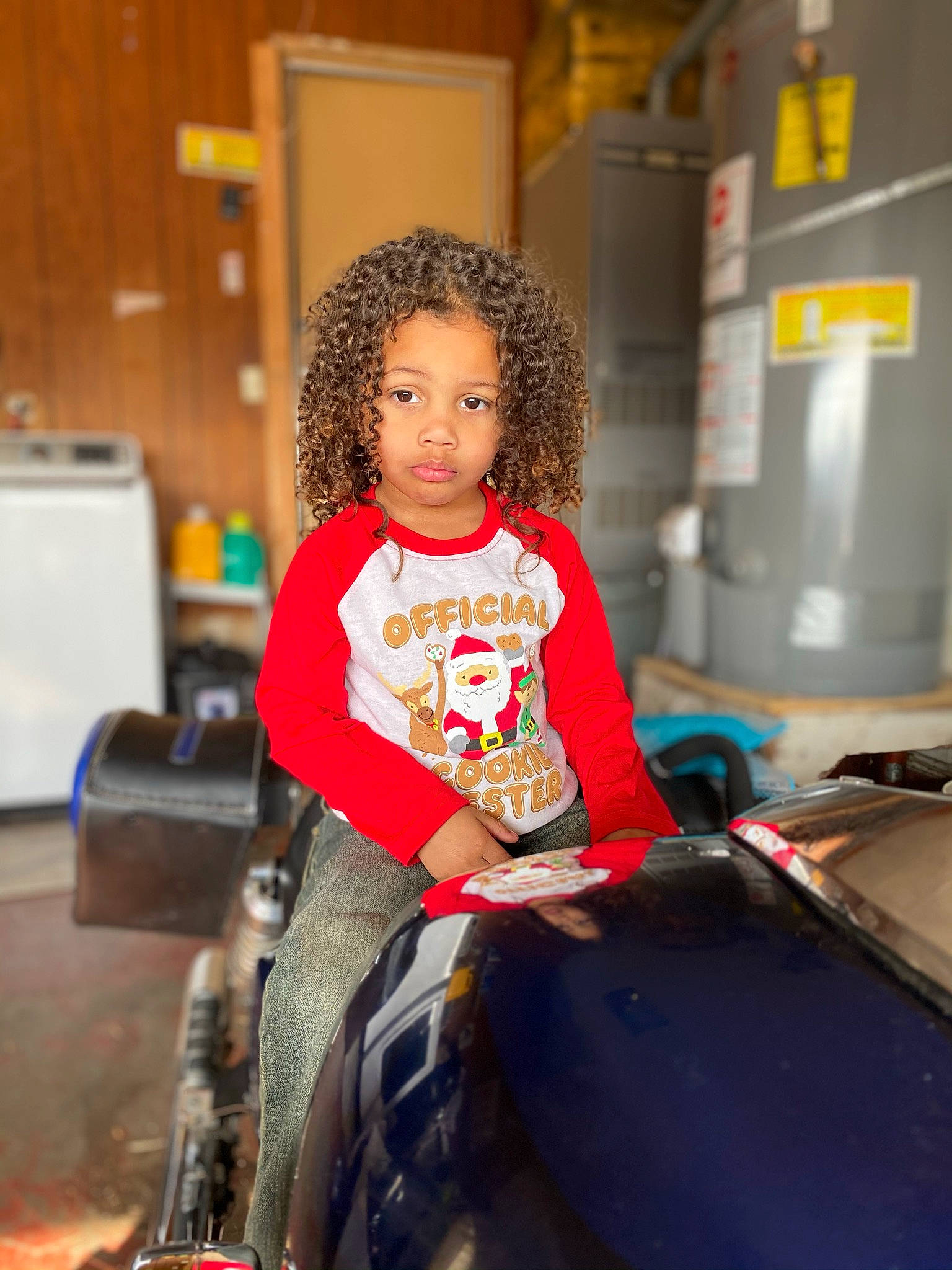 Dominick is registered to the contest to win money with this photo: automotive_design, automotive_tire, chair, child, fashion_design, flooring, fun, happy, home_appliance, leisure, long_hair, motor_vehicle, person, recreation, refrigerator, riding_toy, room, sitting, t_shirt, tire