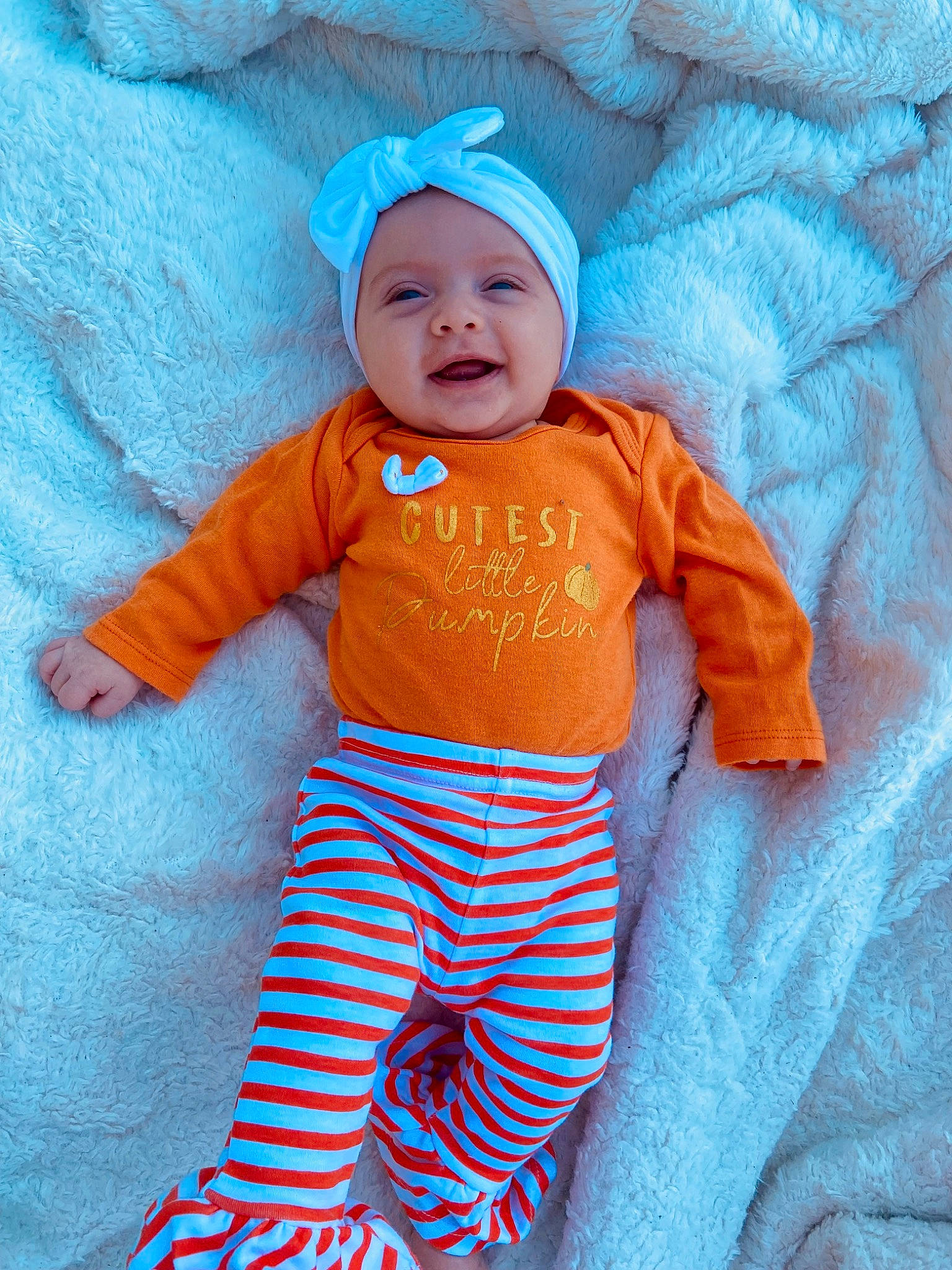 Malaya is registered to the contest to win money with this photo: azure, baby, baby_products, baby_toddler_clothing, child, electric_blue, face, happy, headwear, linens, orange, pattern, peach, people_in_nature, person, sleeve, smile, sportswear, t_shirt, textile