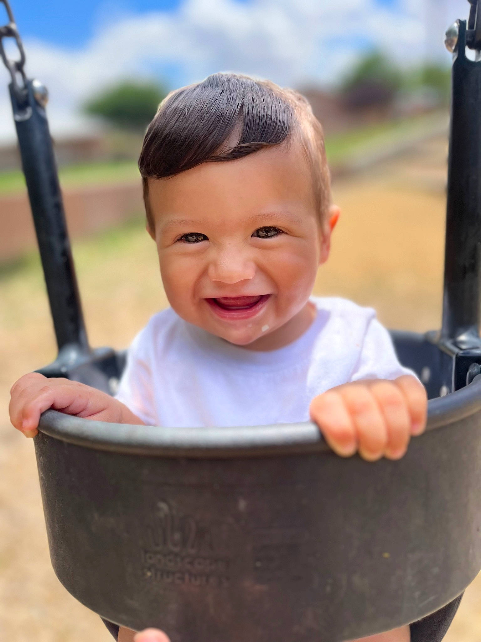 Enrique is registered to the contest to win money with this photo: arm, baby, cheek, chin, eye, face, facial_expression, finger, gesture, hand, happy, head, joy, leisure, person, photograph, skin, sky, sleeve, smile