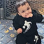 Journey is registered to the contest to win money with this photo: baby, toddler, child, playpen, mattress, star_pattern, moon_pattern, black_hoodie, clothing, sitting, smile, hand_in_mouth, brown_hair, eyes, portrait, indoor, cute, play_area, gate, floor_mat