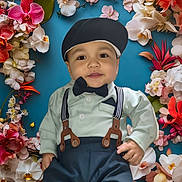 Journey is registered to the contest to win money with this photo: child, baby, toddler, bow_tie, suspenders, cap, portrait, floral_background, orchids, flowers, petals, blue_background, smile, face, eyes, clothing, formal_wear, skin, hand, cutout