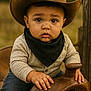 Journey joined the competition — help win amazing prizes! baby, bandana, big_eyes, child, closeup, cowboy_hat, cute, denim, grass_background, hands, leather, neutral_expression, outdoors, portrait, saddle, sitting, toddler, warm_tones, western, wood_post