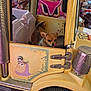 dog, toy_story, amusement_ride, kiddie_ride, toy_car, chihuahua, animal_figure, colorful, playground, wheel, sticker, door, metal, purple_floor, yellow_car, cute, pet, outdoor, fun, amusement_park