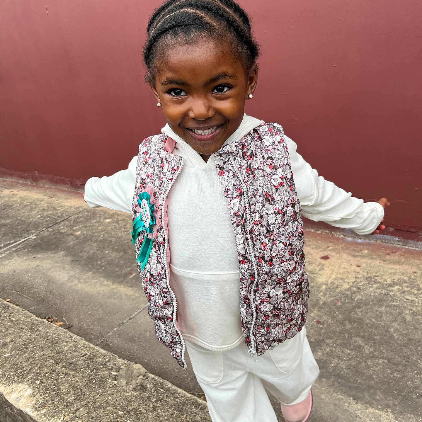 Amelah joined the competition — help win amazing prizes! balance, braided_hair, casual_clothing, child, concrete, curb, earrings, girl, happy, joy, outdoor, person, pink_shoes, portrait, sidewalk, smiling, urban, vest, wall, white_pants