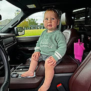 Brock joined the competition — help win amazing prizes! toddler, child, baby, car_interior, seat, leather_seat, sweater, barefoot, drool, center_console, pink_tumbler, window, daylight, green_sweater, curious_expression, head, face, hand, foot, seatbelt