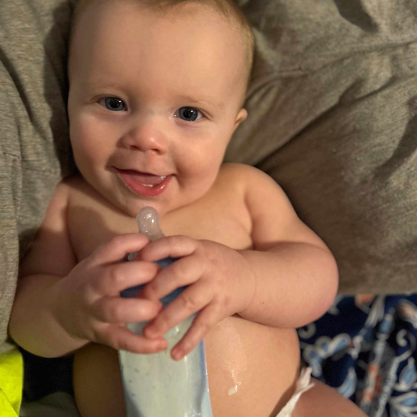 Marcus is registered to the contest to win money with this photo: baby, babylaughing, beverage, bodypart, bottle, cream, cutlery, face, finger, hand, happy, head, medication, milk, person, photography, pill, portrait, smile, spoon