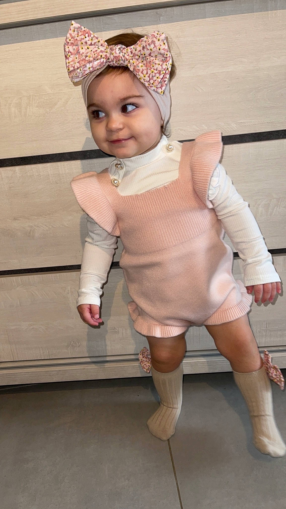 Tessia participe au concours pour gagner de l'argent avec cette photo : baby_toddler_clothing, cap, dress, eye, face, fashion_design, headgear, headwear, human_leg, jewellery, joy, knee, leg, person, pink, skin, sleeve, smile, thigh, toddler