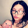 baby, infant, bottle, feeding, woman, young_mother, glasses, portrait, close_up, indoor, cuddling, caregiver, family, face, eyes, hair, shirt, blanket, warm_lighting, selfie