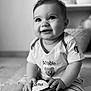 Lizéa participe au concours pour gagner de l'argent avec cette photo : adorable, baby, black_and_white, carpet, child, clothing, cute, happy, home, indoor, infant, person, portrait, rugby_ball, shirt, shorts, sitting, smiling, toys, young