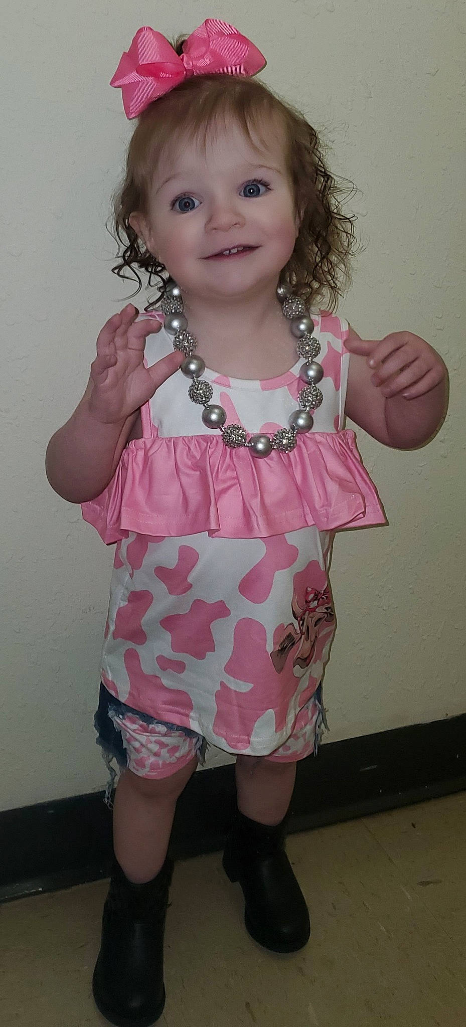 Adalynn is registered to the contest to win money with this photo: baby_toddler_clothing, cheek, day_dress, eye, facial_expression, finger, gesture, hairstyle, happy, head, joy, neck, organ, person, pink, shoulder, skin, sleeve, smile, thumb