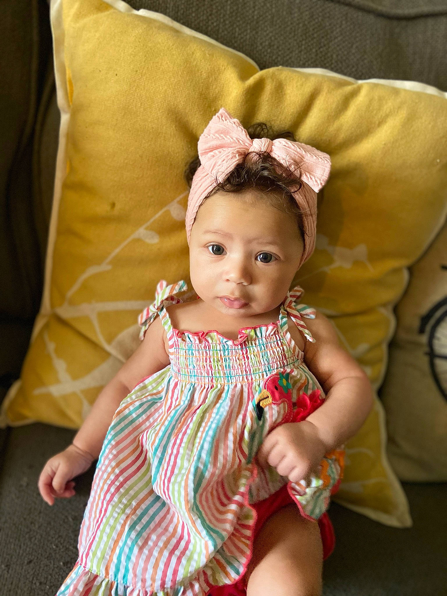 Ashlynn joined the competition — help win amazing prizes! baby, child, child_model, design, dress, fashion_accessory, fawn, furniture, hair_accessory, headgear, linens, pattern, person, pink, sitting, skin, smile, textile, toddler, yellow