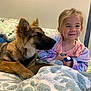 child, dog, bed, blanket, smile, indoor, furniture, pillow, young_child, pet, cozy, comfort, friendship, warm, casual, happy, relaxing, resting, fur, portrait
