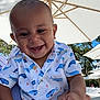 baby, child, smiling, happy, outdoor, umbrella, shirt, whale_pattern, person, hand, trees, daylight, sunny, nature, family, holding, blue_sky, casual_clothing, infant, cheerful