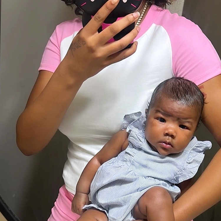 Mulanni is registered to the contest to win money with this photo: baby, child, woman, mirror, selfie, phone, phone_case, hello_kitty, pink_clothing, white_clothing, striped_dress, sandals, curly_hair, arm, hand, indoor, reflection, casual, portrait, holding