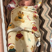 Merry is registered to the contest to win money with this photo: baby, blanket, sleeping, child, toy, knitted_blanket, christmas, holiday, cute, face, pillow, soft, wrapped, indoors, infant, peaceful, cozy, plush, decorative, resting