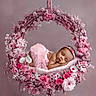 baby, sleeping, pink, floral_wreath, flowers, headband, tutu, soft, cute, newborn, peaceful, portrait, decorative, flower_arrangement, infant, resting, delicate, adorable, studio_photo, child