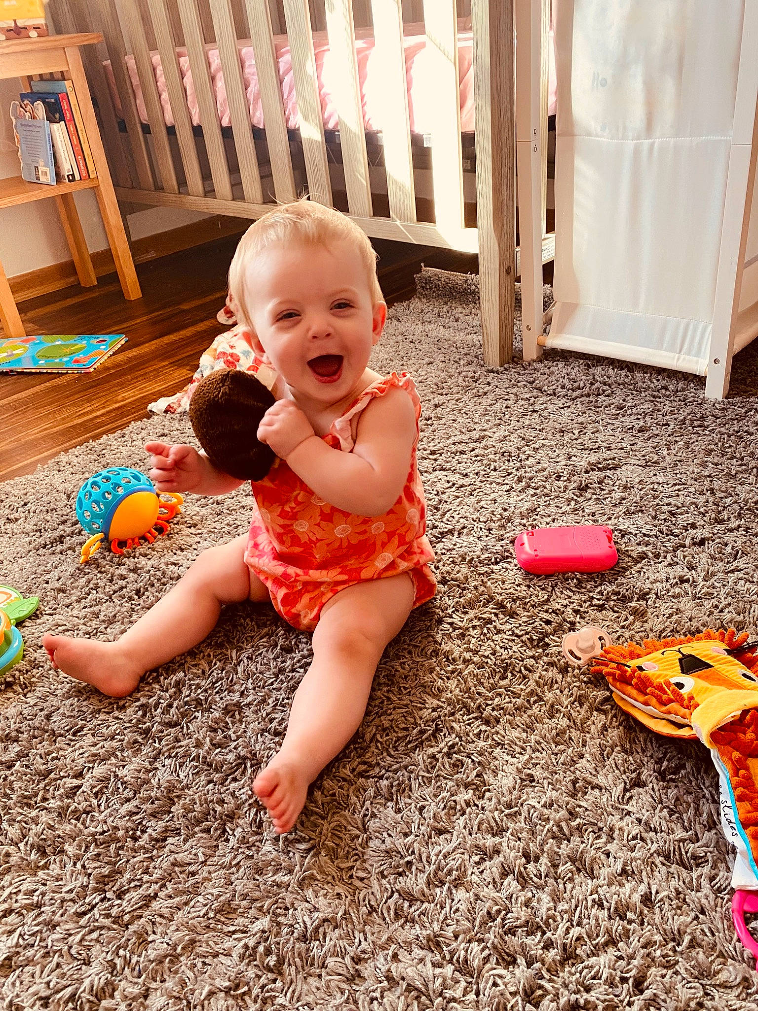 Waverly is registered to the contest to win money with this photo: baby, baby_toddler_clothing, child, finger, floor, flooring, foot, fun, grass, happy, hardwood, human_leg, leg, orange, people_in_nature, person, sitting, smile, thigh, toddler