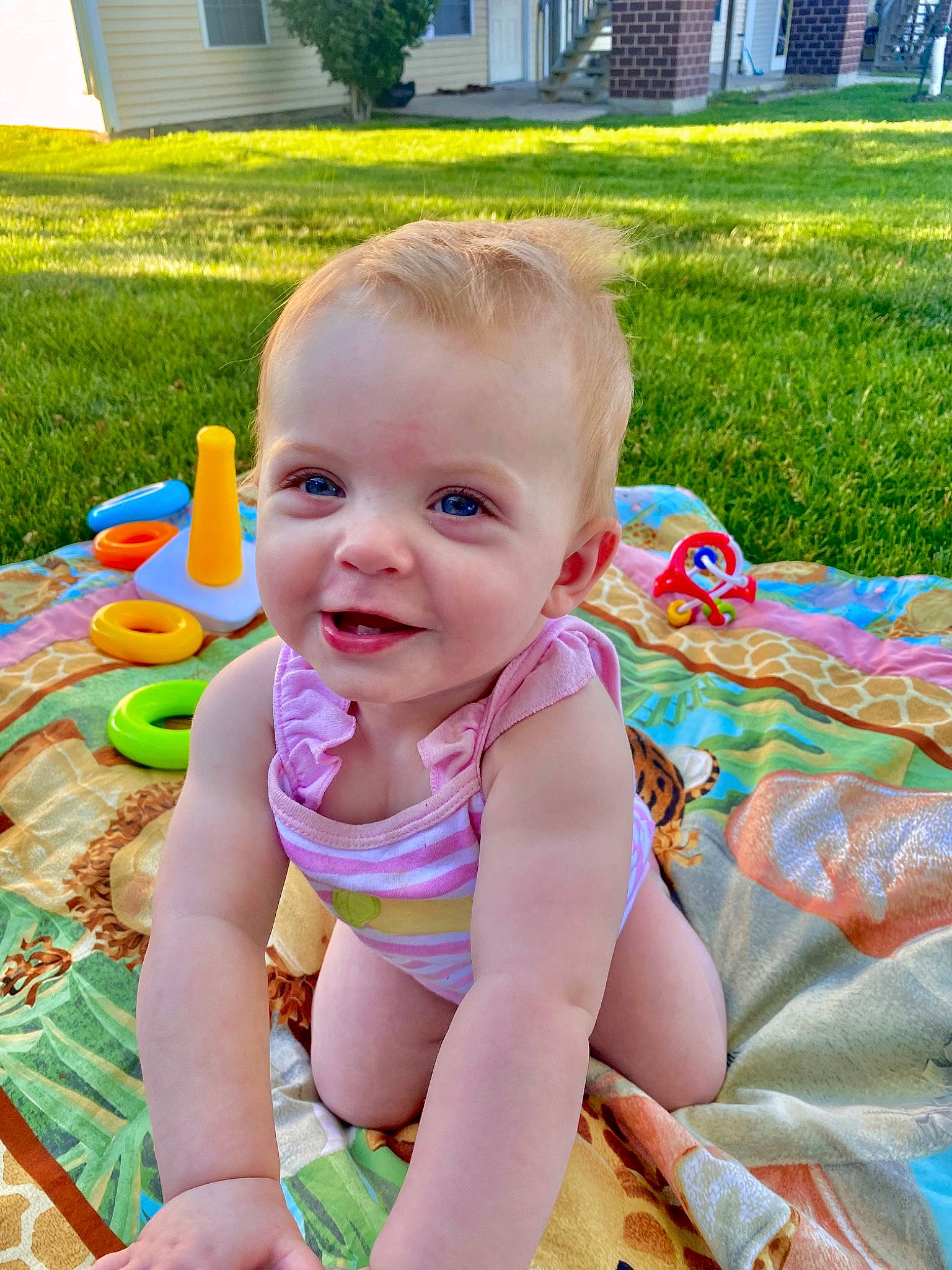 Waverly is registered to the contest to win money with this photo: baby, baby_playing_with_toys, baby_toddler_clothing, building, child, fun, grass, green, happy, leisure, people_in_nature, person, pink, plant, public_space, recreation, sitting, smile, thigh, toddler