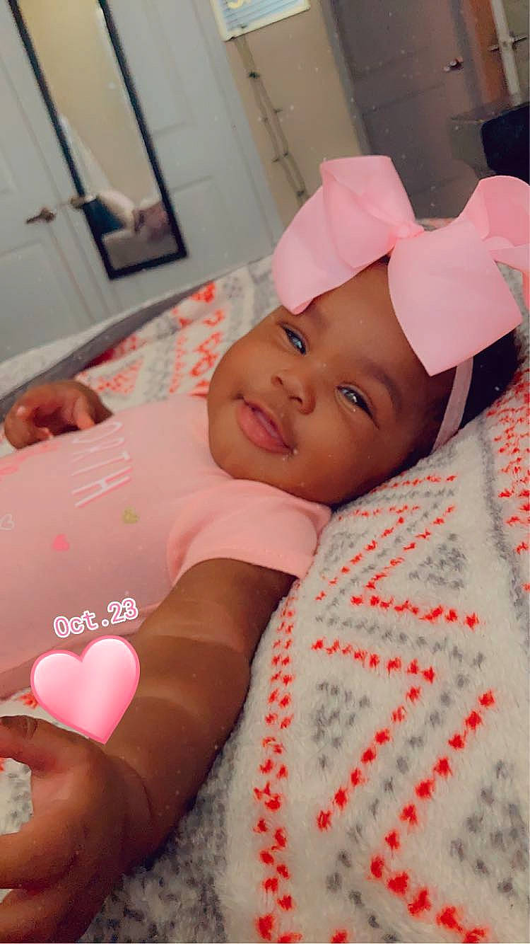 Tuuts is registered to the contest to win money with this photo: baby, baby_toddler_clothing, bedding, carmine, child, comfort, eyelash, happy, hat, headwear, linens, lip, magenta, mouth, pattern, person, pink, room, skin, sleeve