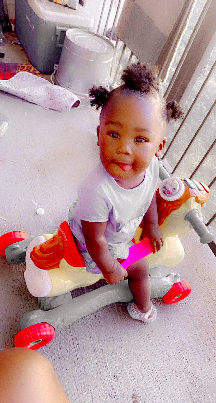 Tuuts is registered to the contest to win money with this photo: baby, baby_toddler_clothing, child, facial_expression, flooring, fun, happy, human_leg, joy, knee, magenta, person, pink, red, shoe, shorts, sitting, skin, sleeve, smile