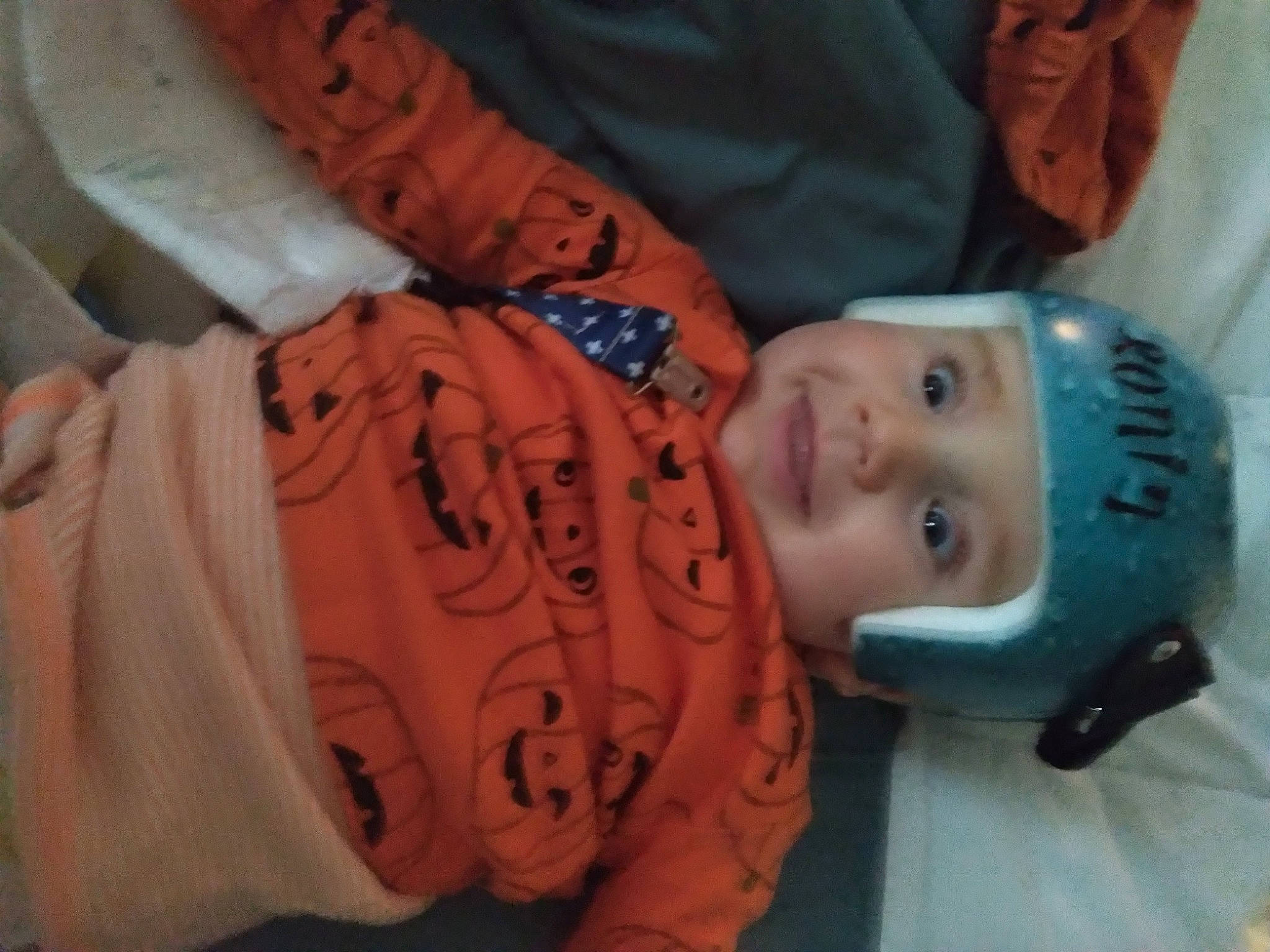 Ronin is registered to the contest to win money with this photo: arm, baby, baby_toddler_clothing, cheek, child, chin, eye, facial_expression, finger, forehead, fun, head, headwear, human_body, joy, mouth, nose, orange, person, skin