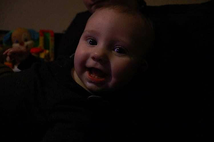 Jiraiya is registered to the contest to win money with this photo: baby, baby_toddler_clothing, cheek, child, comfort, darkness, ear, flash_photography, fun, happy, head, laugh, night, nose, person, portrait_photography, room, sitting, smile, toddler