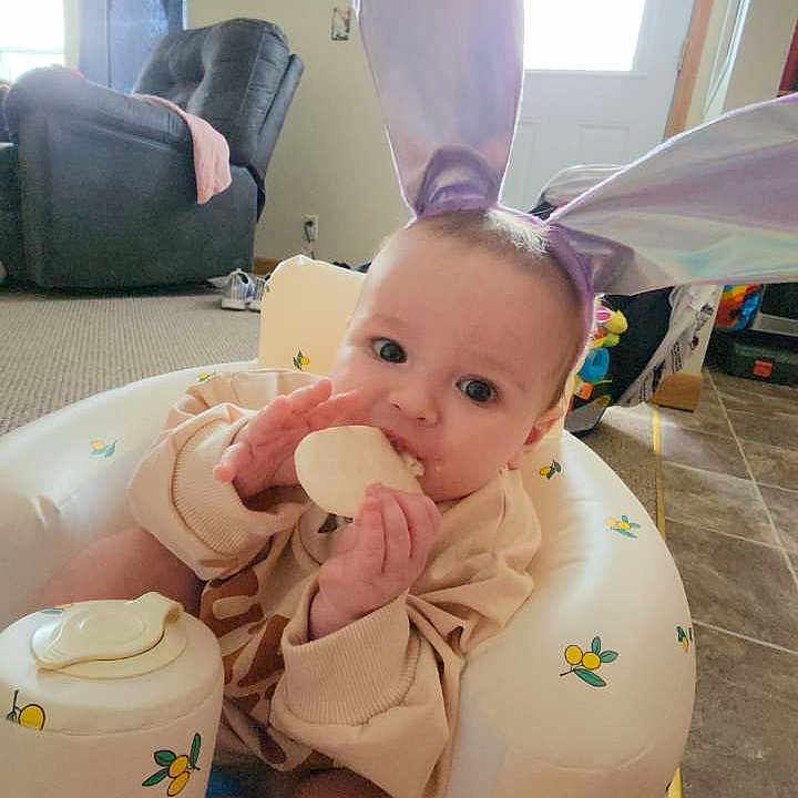 Daisy is registered to the contest to win money with this photo: architecture, baby, building, couch, cream, cushion, cutlery, dessert, face, food, furniture, head, homedecor, icing, indoors, livingroom, person, photography, portrait, spoon