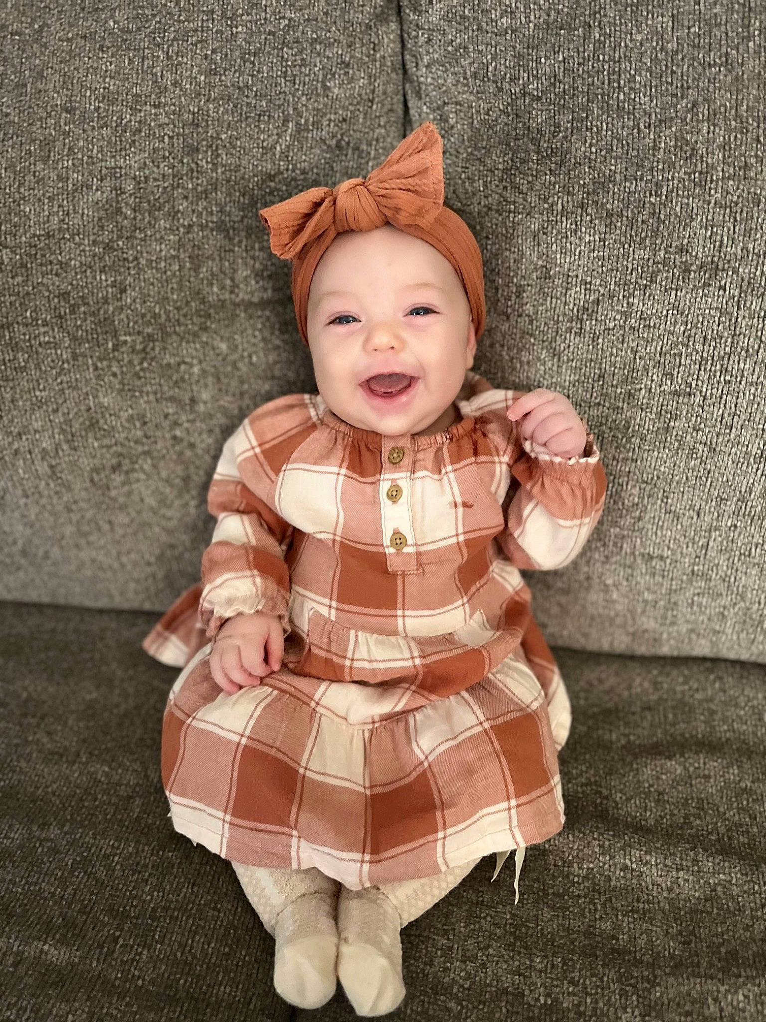 Annabelle is registered to the contest to win money with this photo: baby, baby_toddler_clothing, child, costume, costume_hat, doll, fashion_accessory, happy, head, headwear, one_piece_garment, pattern, peach, person, plaid, skin, sleeve, smile, tartan, toddler