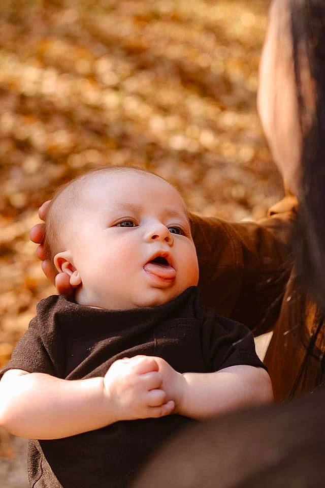 Declan is registered to the contest to win money with this photo: baby, baby_toddler_clothing, cheek, child, eye, face, facial_expression, flash_photography, fun, grass, happy, iris, lip, nose, people_in_nature, person, sitting, skin, toddler, tree