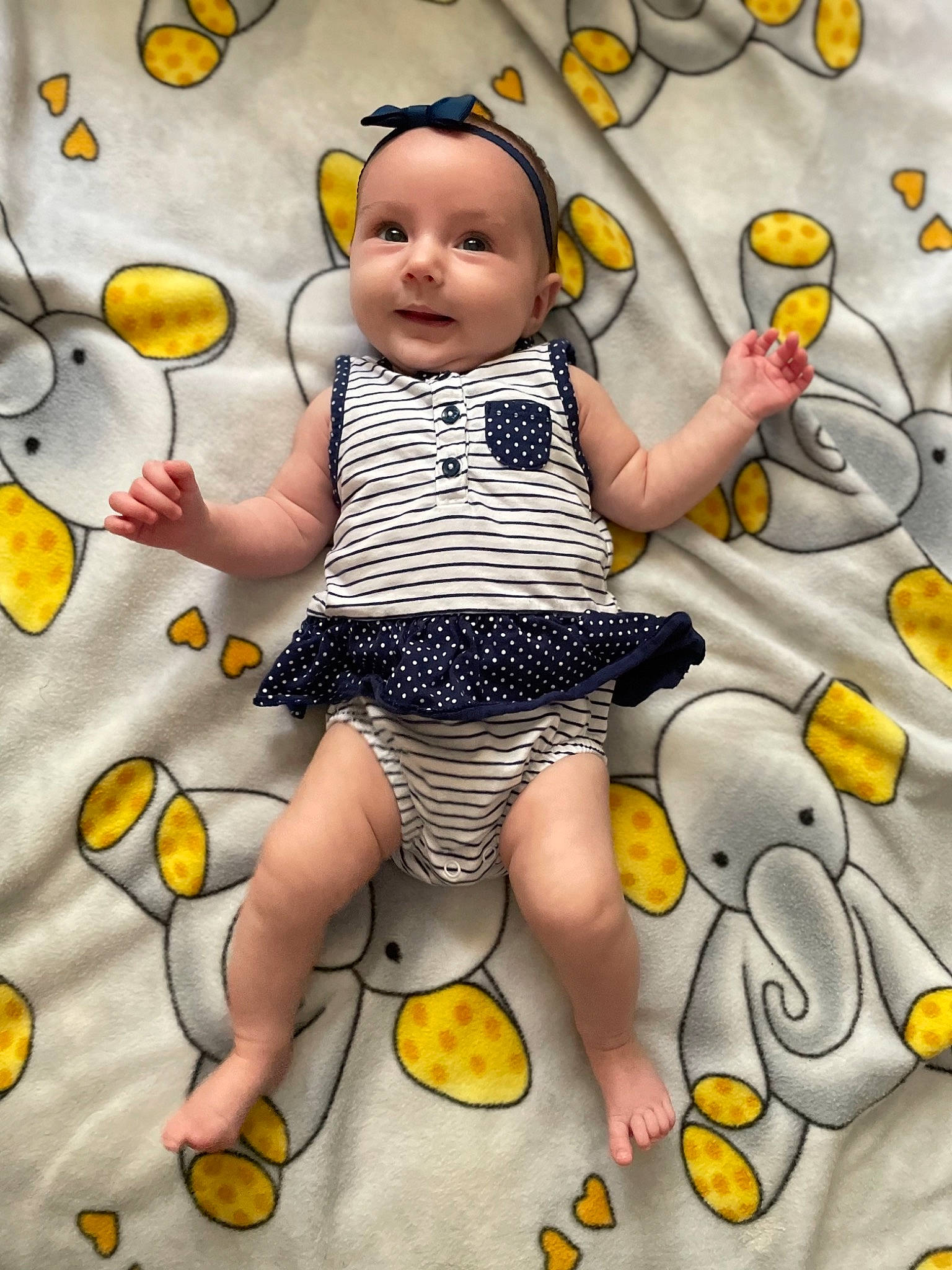 Everest is registered to the contest to win money with this photo: arm, baby, baby_toddler_clothing, beauty, child, finger, fun, gesture, happy, pattern, people, people_in_nature, person, photograph, sleeve, smile, textile, thumb, toddler, white