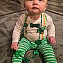 Jacksen joined the competition — help win amazing prizes! baby, infant, child, sitting, st_patricks, shamrock, green_beads, necklace, striped_pants, onesie, bow_tie_print, socks, rug, indoor, home_interior, looking_up, cute, portrait, hands, floor