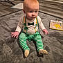 Jacksen joined the competition — help win amazing prizes! baby, infant, sitting, green_striped_pants, beads, carpet, toy_book, indoor, rug, socks, cabinet, wooden_floor, cute, portrait, hands, face, eyes, expression, playtime, living_room