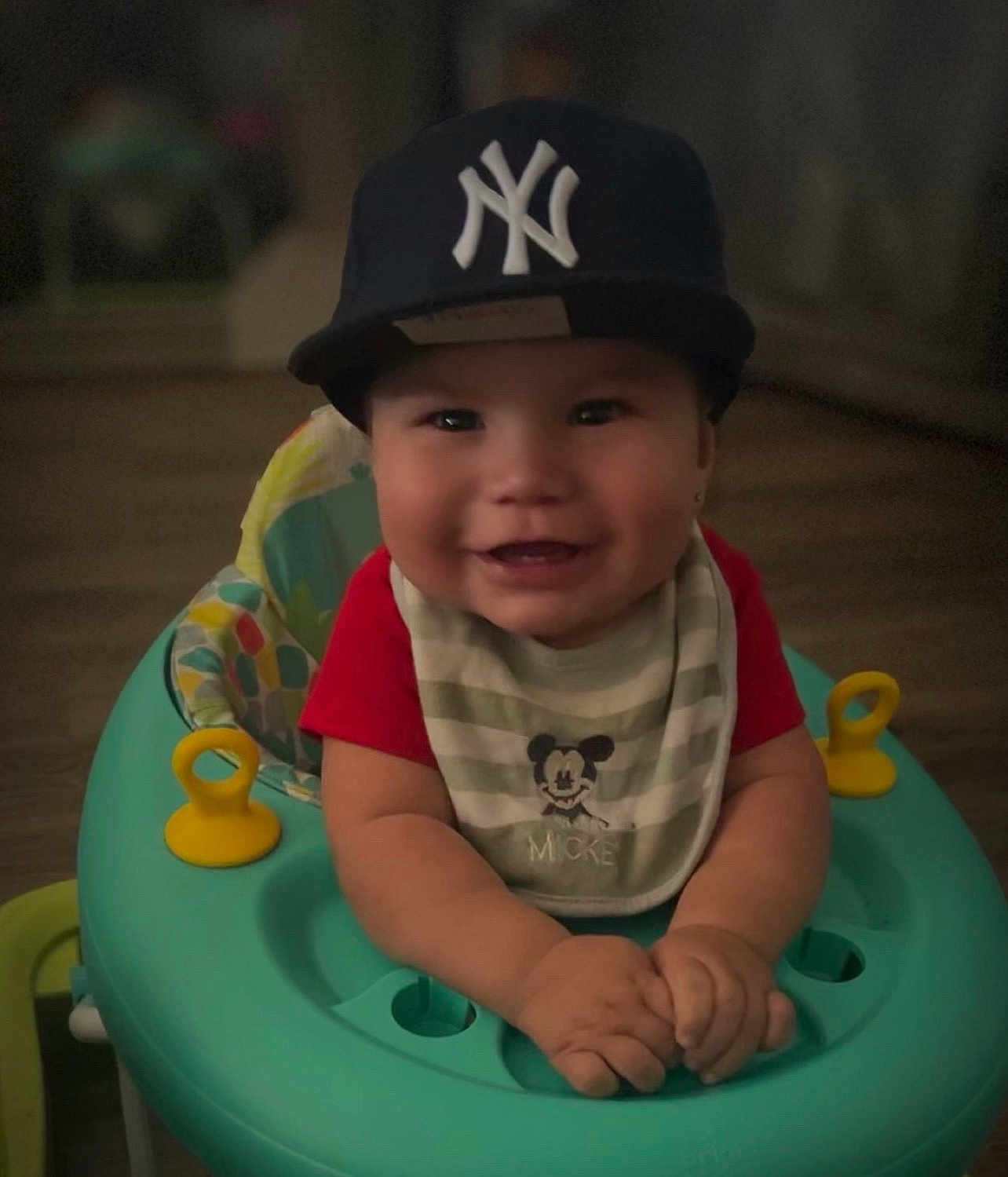 Acito is registered to the contest to win money with this photo: baby, child, smile, cap, bib, mickey_mouse, baby_walker, indoor, happy, face, hands, clothing, toy, person, headwear, infant, cute, childhood, playtime, young