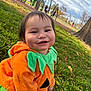 Acito is registered to the contest to win money with this photo: toddler, child, pumpkin_costume, orange_clothing, green_leaves, grass, playground, smiling, happy, outdoor, autumn, tree, park, face, person, cute, seasonal, fall, baby, costume