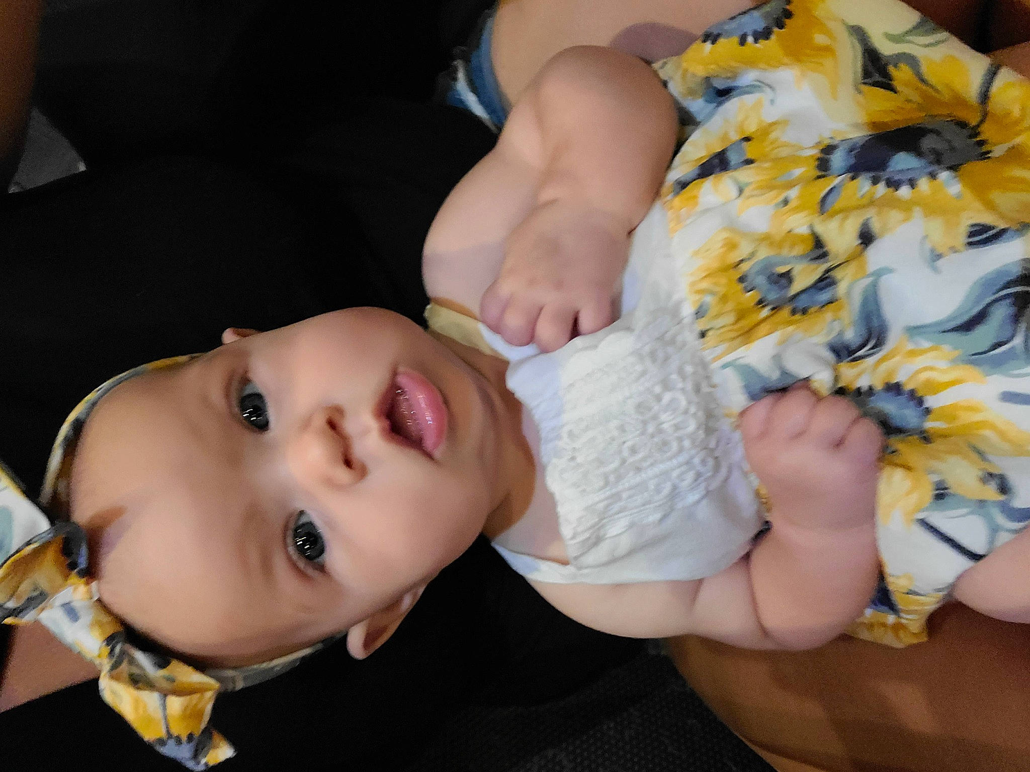 Keira is registered to the contest to win money with this photo: arm, baby, baby_toddler_clothing, cheek, child, dress, eyelash, finger, gesture, hand, happy, human_leg, lip, mouth, neck, nose, person, skin, thigh, toddler