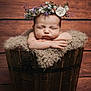 arms, baby, child, closeup, cute, face, flower_crown, fluffy_blanket, hands, head, infant, newborn, peaceful, portrait, resting, sleeping, soft_texture, studio_photo, wood_background, wooden_bucket