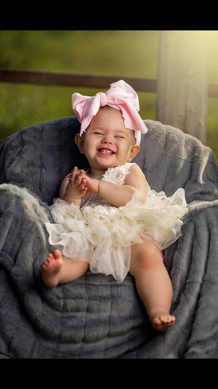 Brynley is registered to the contest to win money with this photo: baby, baby_laughing, cheek, child, facial_expression, fashion_accessory, fur, hair_accessory, happy, headgear, joy, person, photograph, photography, pink, portrait, portrait_photography, product, sitting, skin