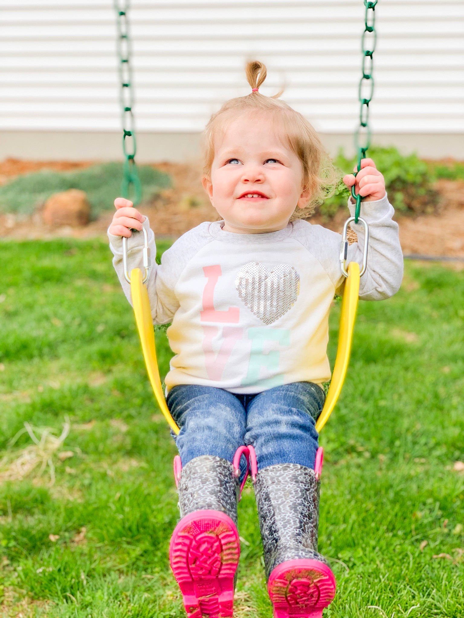 Hartley joined the competition — help win amazing prizes! baby, child, fun, grass, happy, joy, outdoor_play_equipment, person, play, playground, recreation, smile, swing, toddler