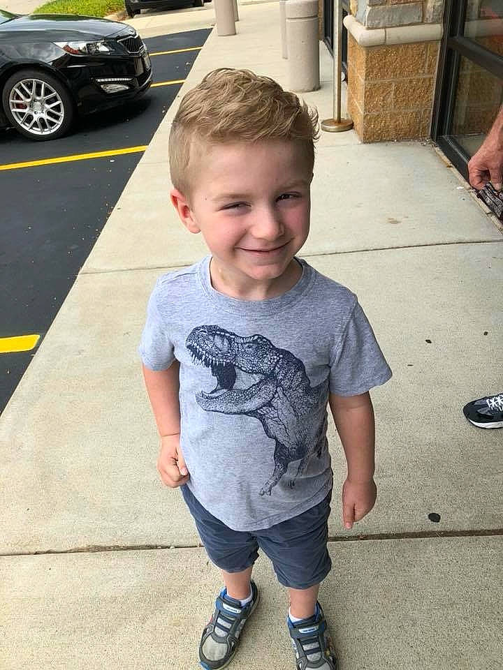 Liam is registered to the contest to win money with this photo: car, child, cool, family_car, footwear, hairstyle, joy, luxury_vehicle, male, person, shoe, standing, summer, t_shirt, toddler, vacation, vehicle, vehicle_door