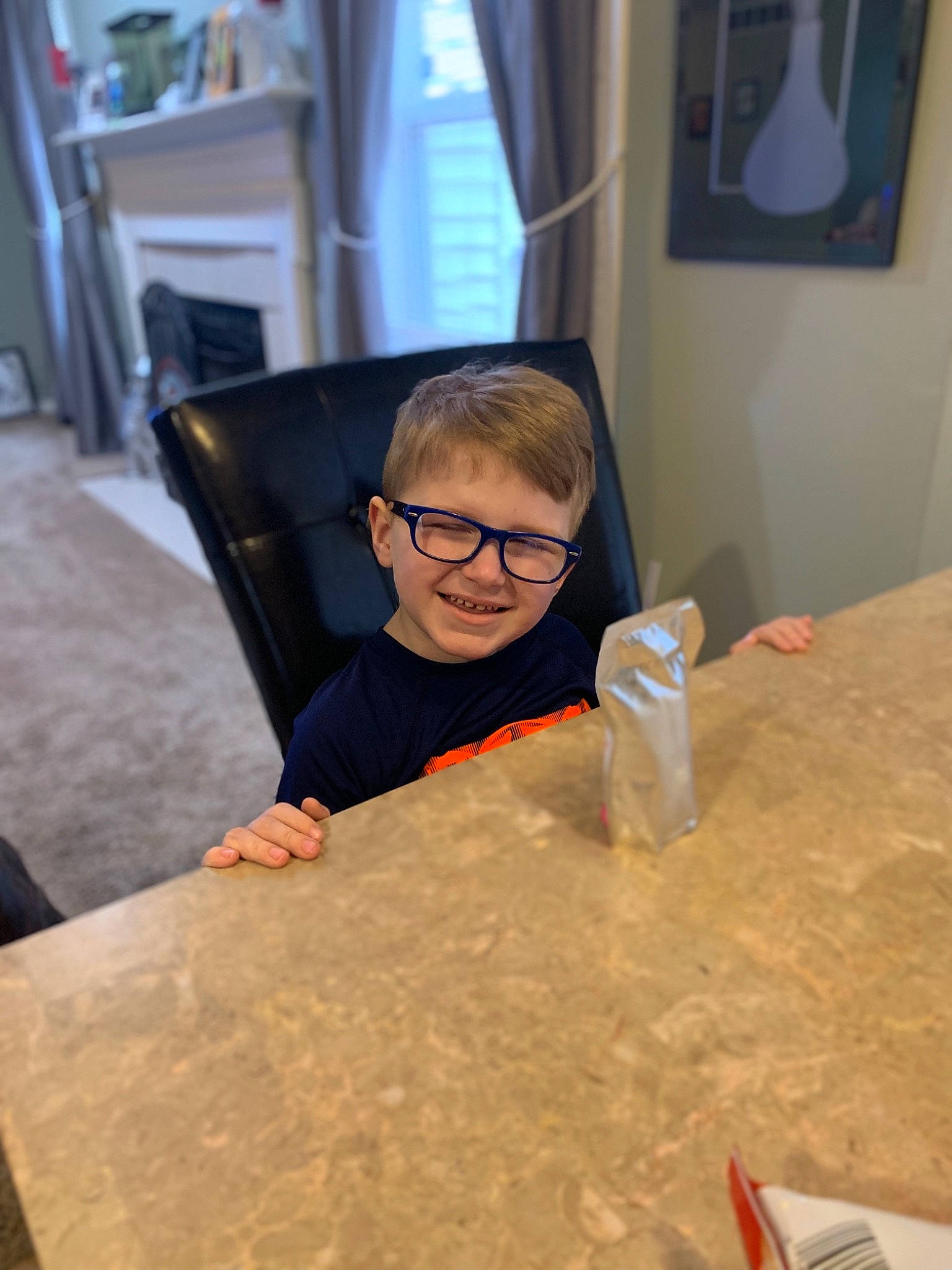 Liam is registered to the contest to win money with this photo: art, eyewear, floor, flooring, furniture, glass, glasses, joy, person, table, tourist_attraction, vacation, vision_care, wood