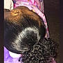 bed, black_hair, blanket, child, closeup, colorful, curly_hair, curly_ponytail, fabric, hair, hand, head, indoor, pattern, ponytail, resting, skin, sleeping, soft, texture
